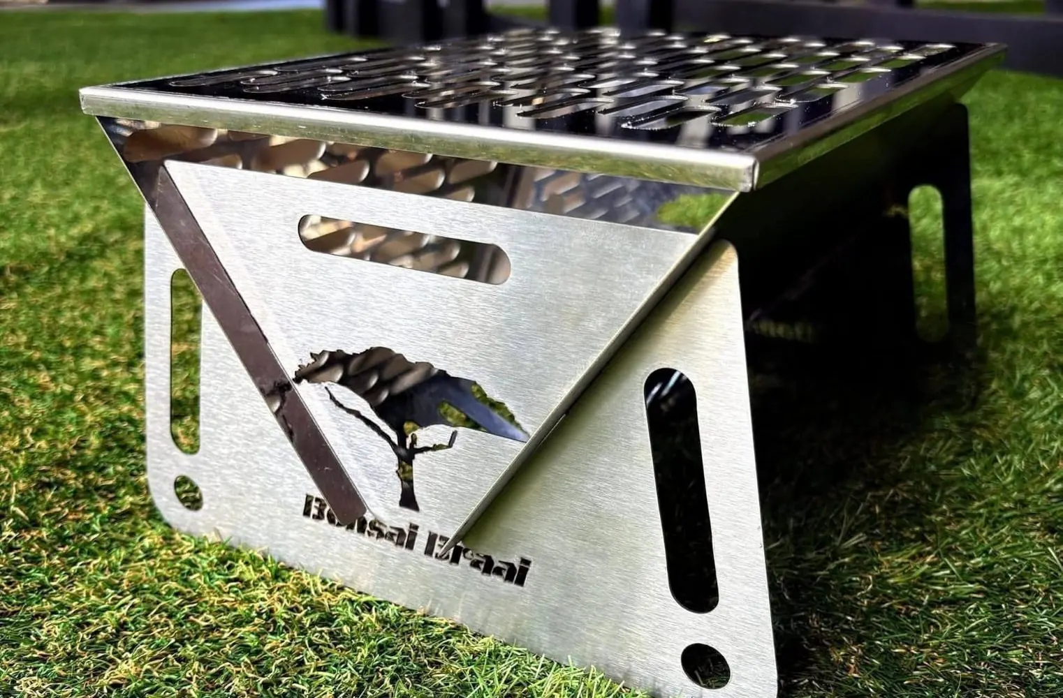 The bare stainless-steel Bonsai Braai standing on grass